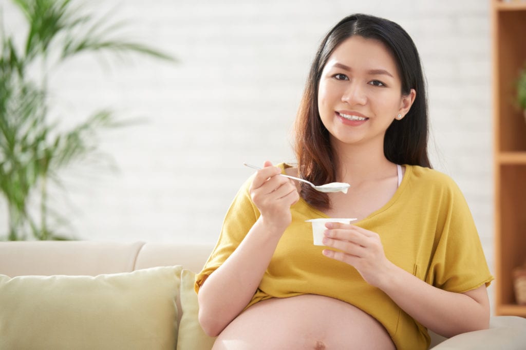 Pregnant woman eating healthful food