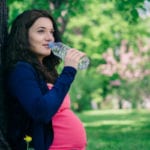 mom-to-be drinking water